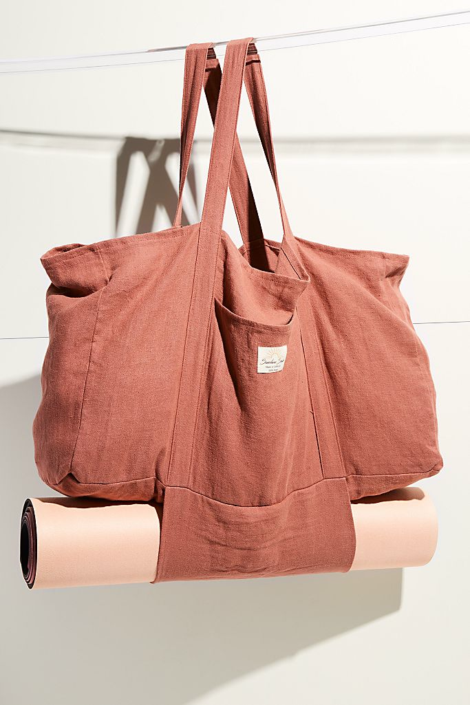 Terra cotta Hemp Market Bag hanging with a peach yoga mat